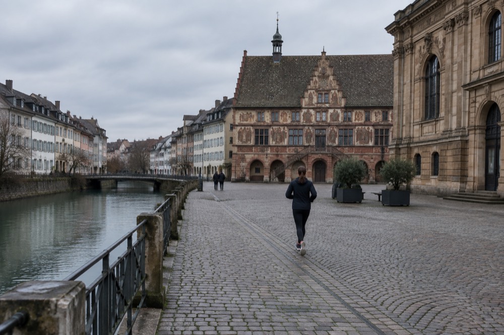 Historic stone buildings and a museum facade beside a quiet square in central Mulhouse