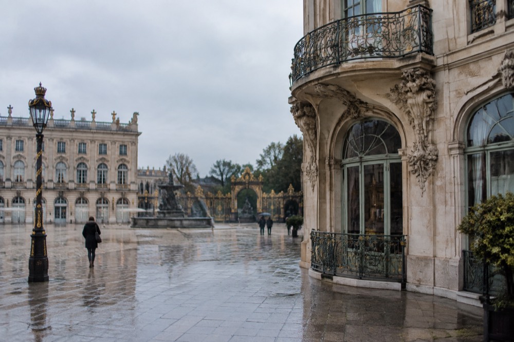 Ornate art nouveau building facade with curved ironwork balcony and botanical ornament