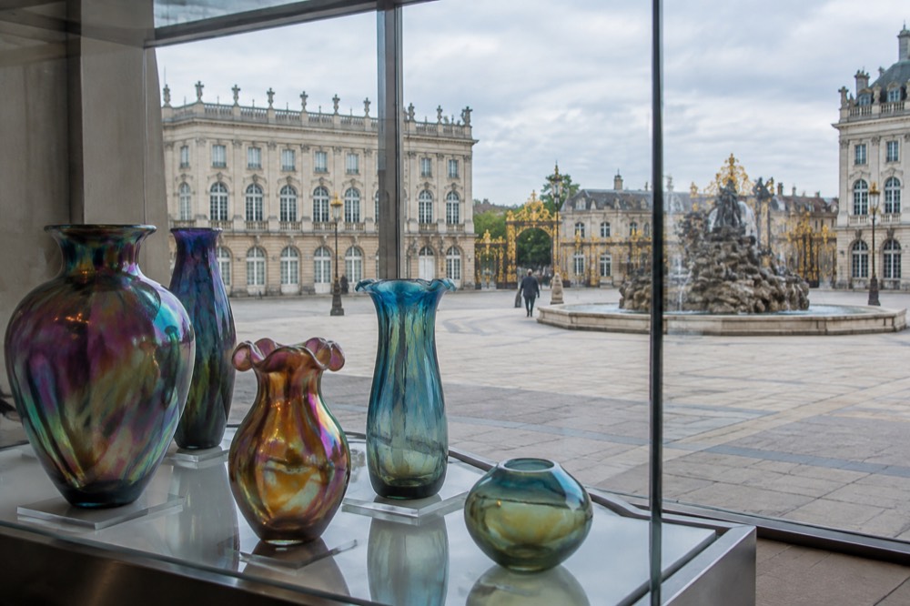Display of iridescent art glass vases in a museum case