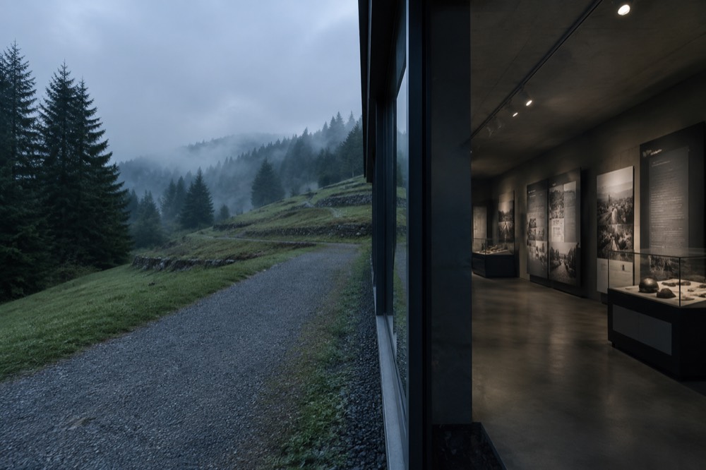 A museum interior with information panels and display cases lit quietly along a wall
