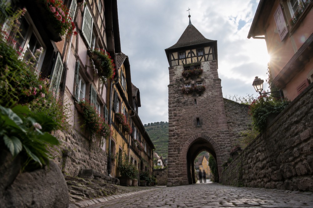 A stone gate tower marking the entrance to a walled Alsatian village