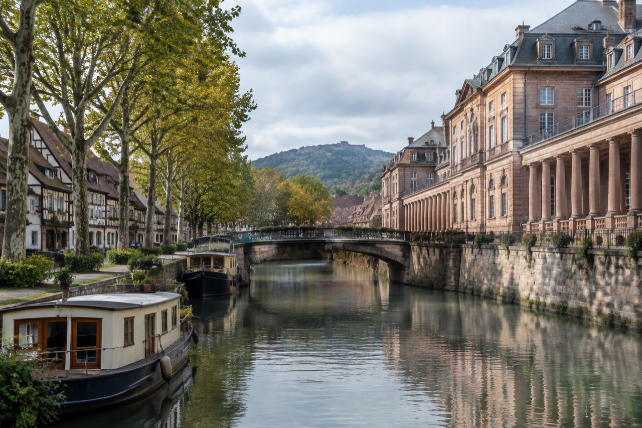 Half-timbered houses along a quiet canal in a small Alsatian town