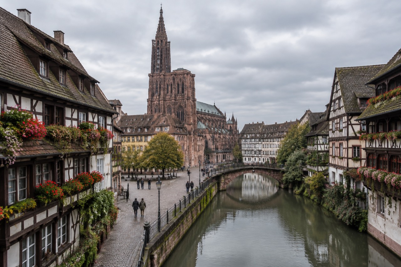 Half-timbered houses along a canal in Strasbourg, France, with flowers on the balconies