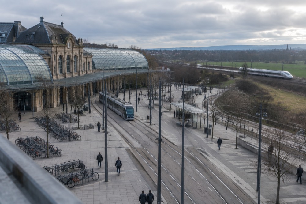 A modern high-speed train travelling through green countryside in eastern France