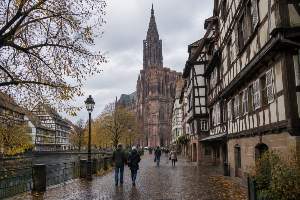 A Strasbourg street in late autumn with half-timbered houses and wet cobblestones in the old town