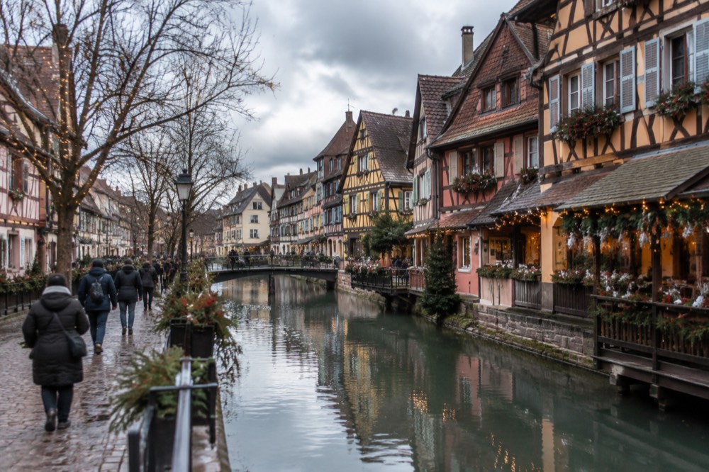 Half-timbered houses decorated with lights and wreaths in Colmar's old town