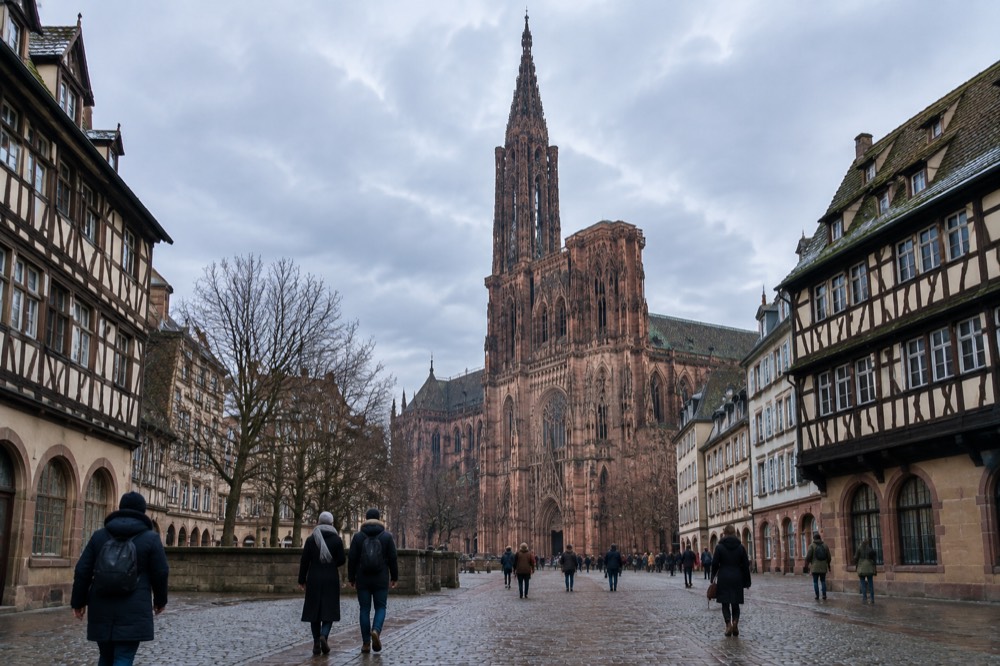 Strasbourg Cathedral's single spire rising above the old town rooftops in winter light