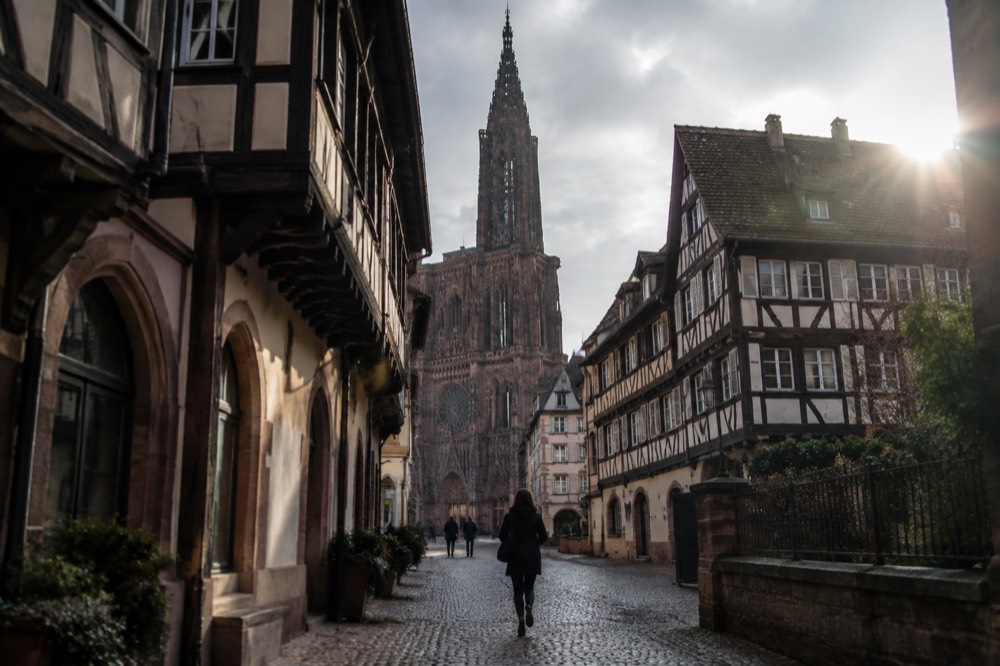 The single spire of Strasbourg Cathedral rising above old rooftops
