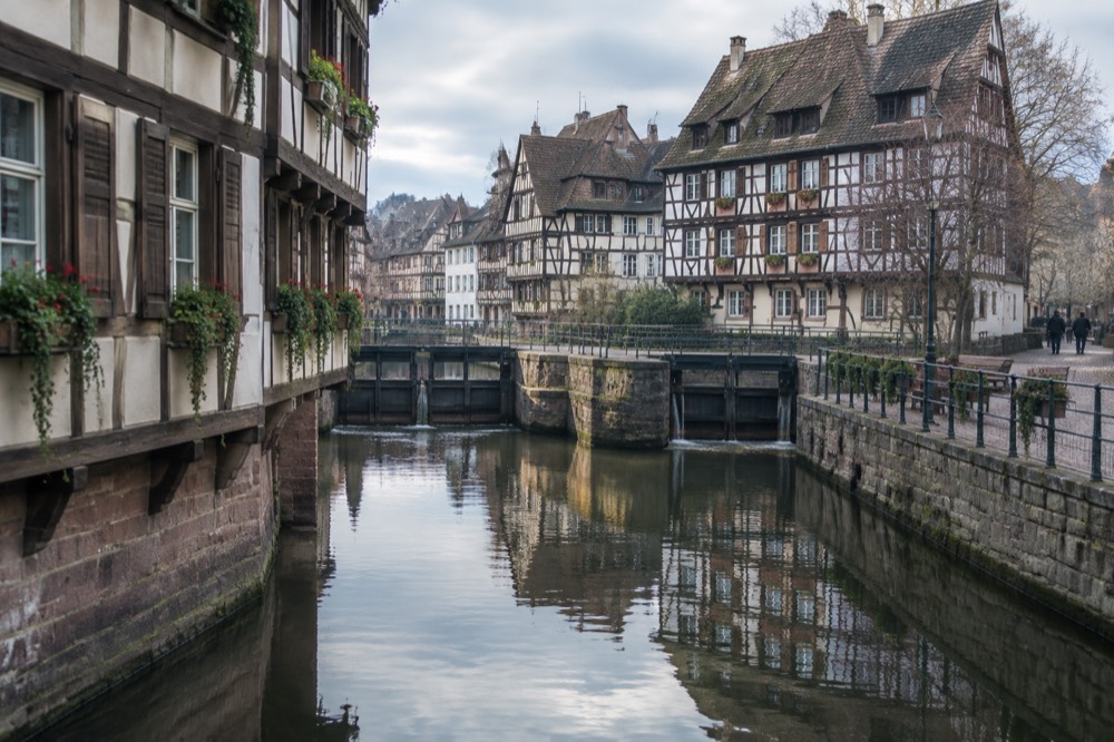 Timber-framed buildings reflected in the water of Petite France