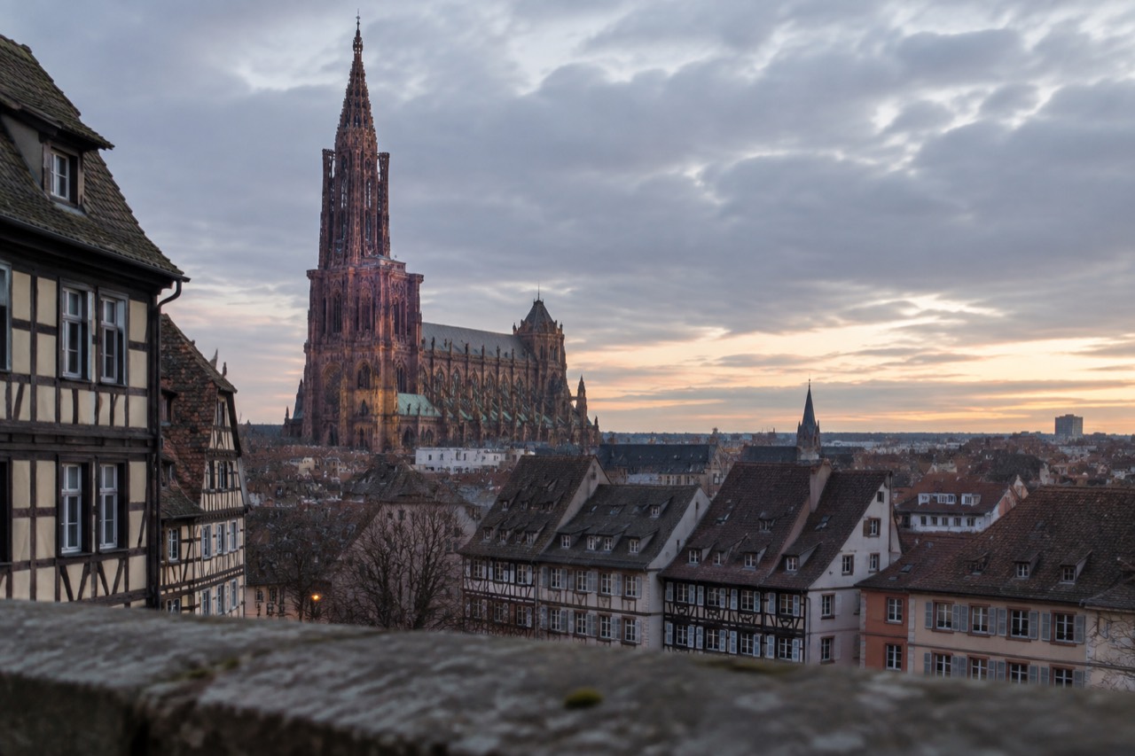 Strasbourg Cathedral and old rooftops seen across the city at dusk