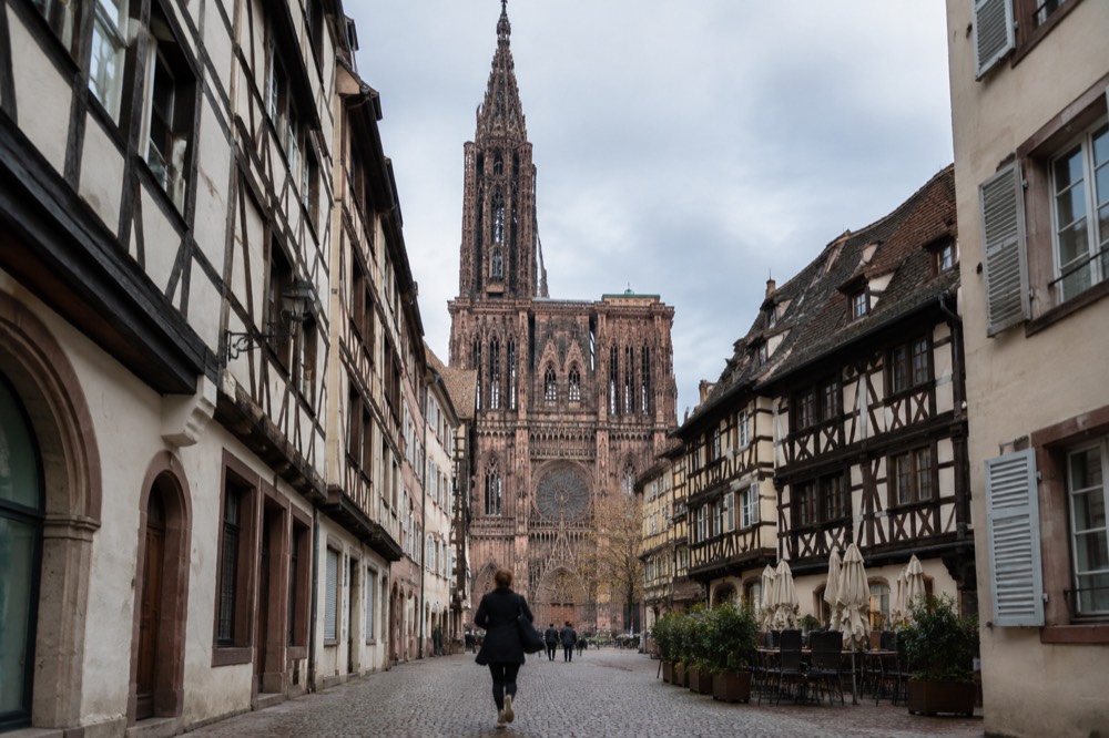 Gothic cathedral facade rising above rooftops in Strasbourg old town