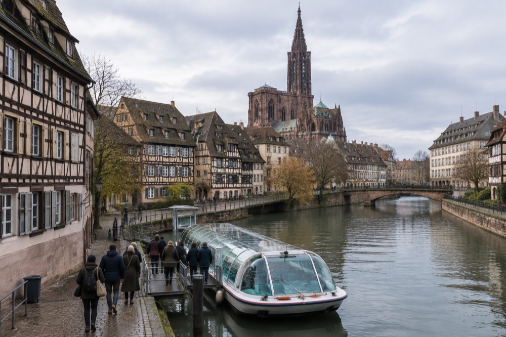 Travellers boarding a river boat at a Strasbourg canal jetty