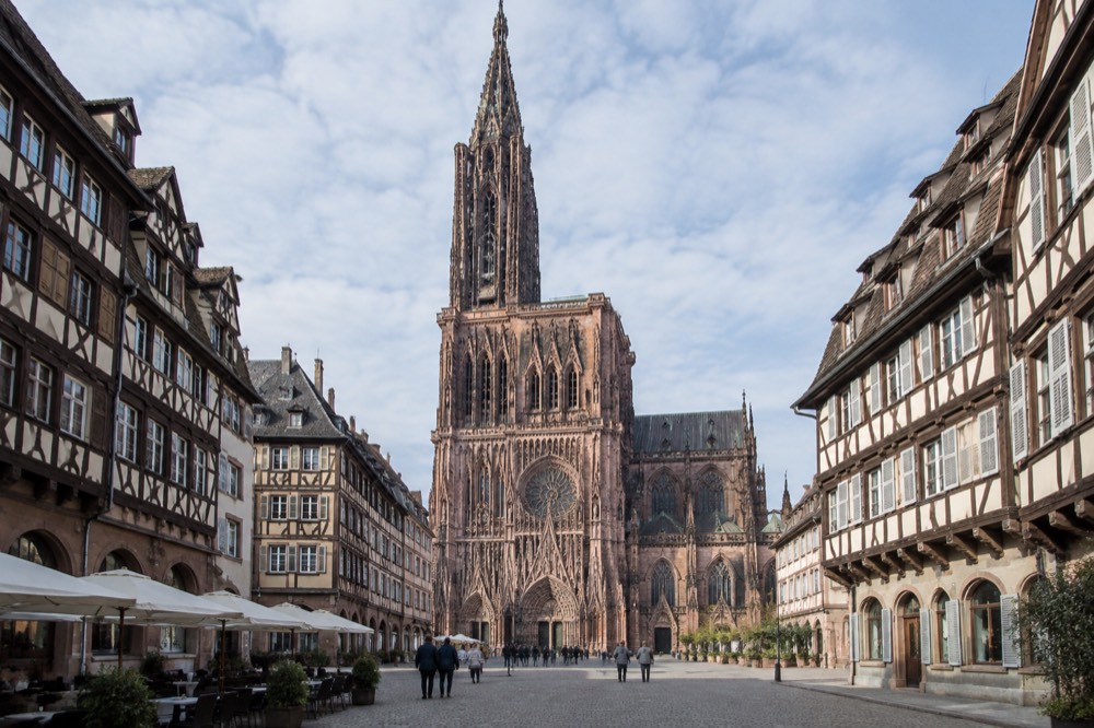 The single Gothic spire of Strasbourg Cathedral rising above rooftops