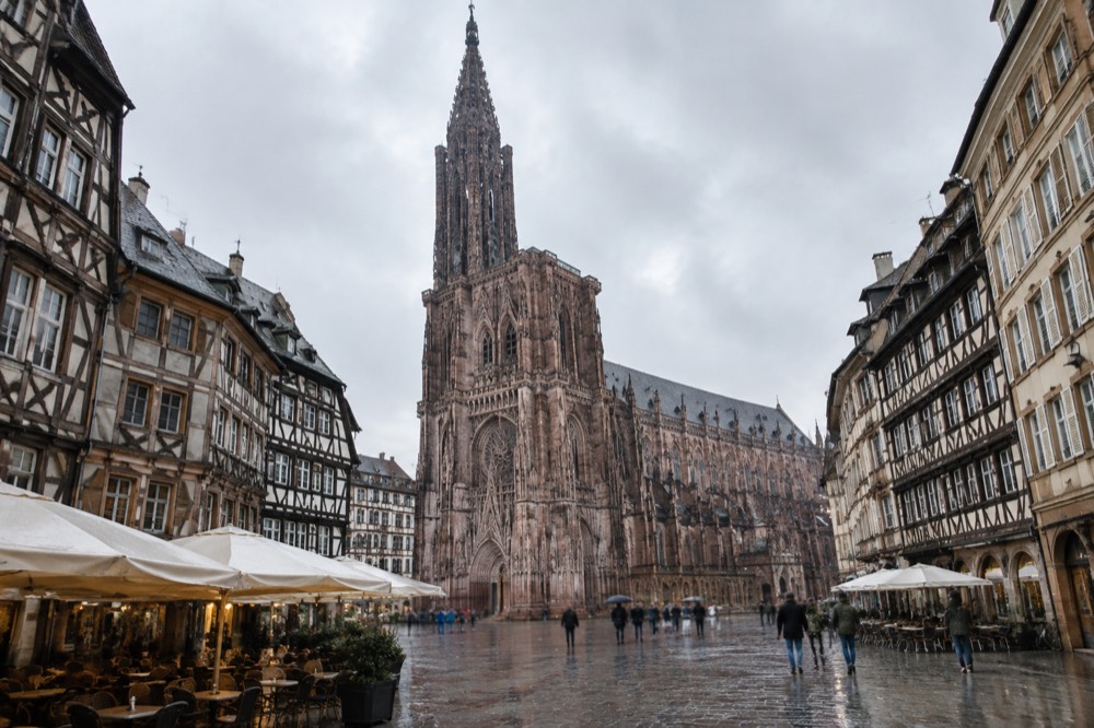 Level pedestrian square in Strasbourg with café terraces and historic facades