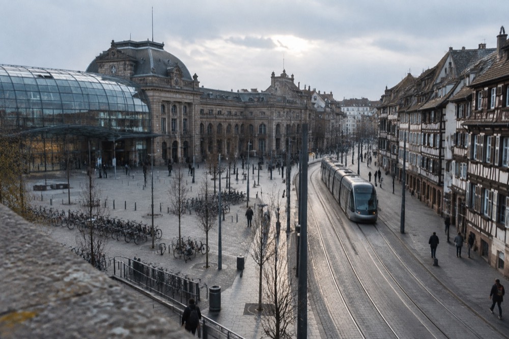 A tram gliding along a street of half-timbered buildings in a city centre