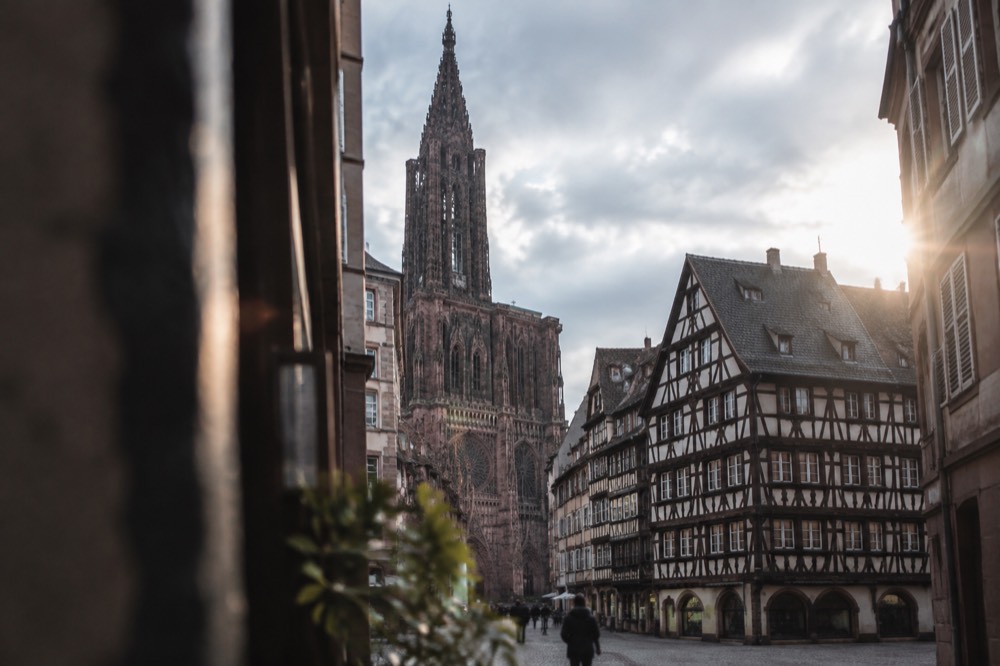 A Gothic cathedral facade rising above narrow streets and old rooftops