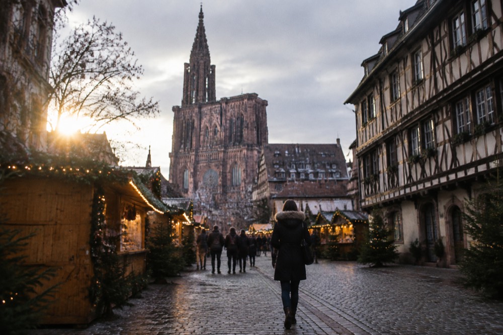 Christmas market chalets with festive lights on a square in Strasbourg