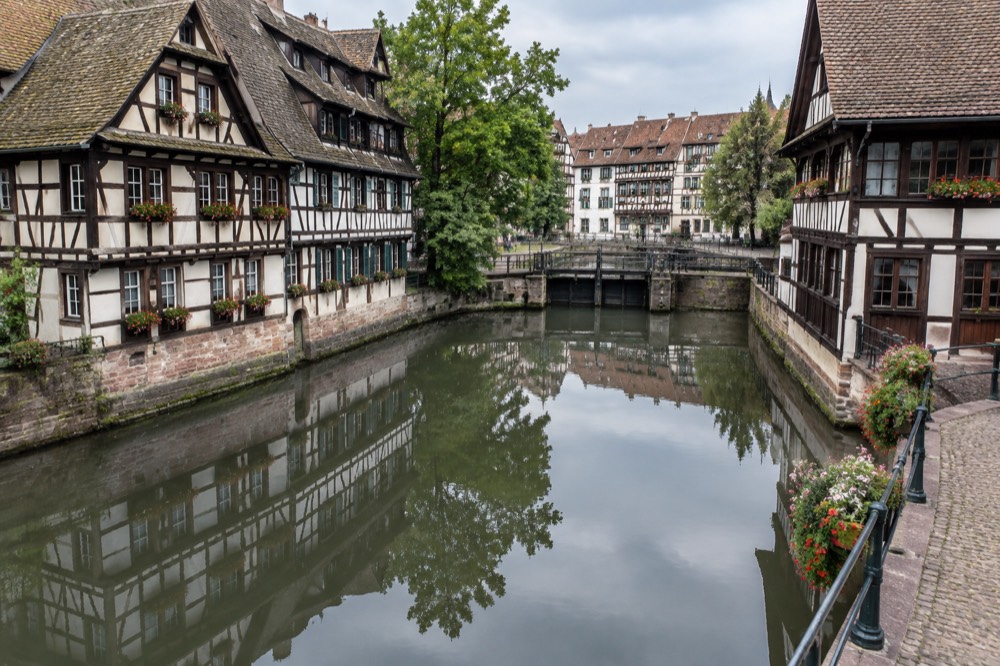 Half-timbered houses of Petite France reflected in the still water of the River Ill in Strasbourg