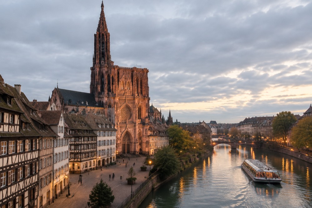 An evening boat cruise on the River Ill with the lights of Strasbourg reflecting on the water