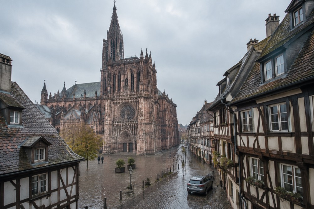 A hire car parked on a quiet Strasbourg street with half-timbered buildings behind it