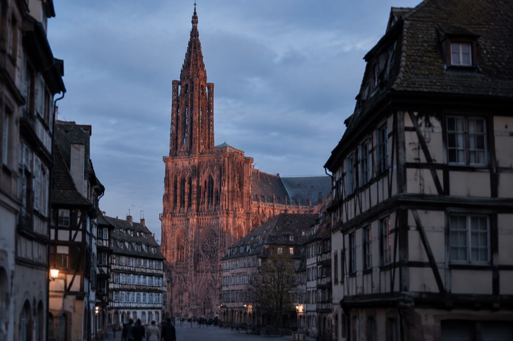 Evening light on the cathedral facade above the old town rooftops