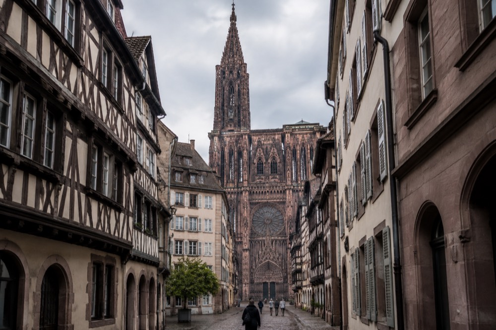 The Gothic west front of Strasbourg Cathedral seen from a narrow street in the old town