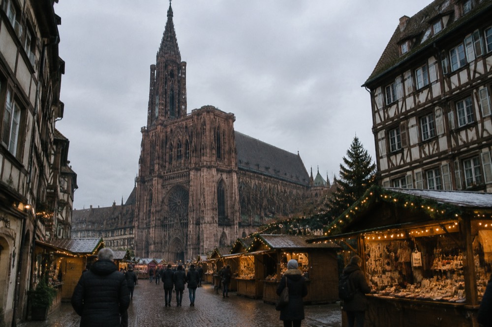 Festive chalets and lights on a square in front of Strasbourg Cathedral