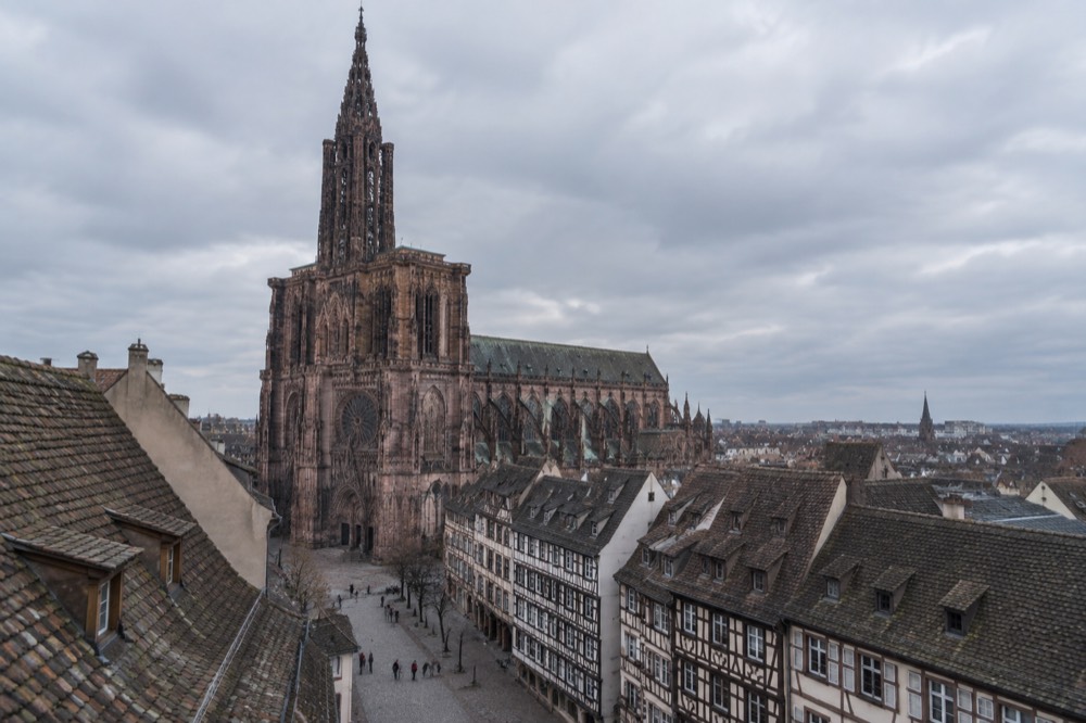 The single spire of Strasbourg Cathedral rising above rooftops of the old town
