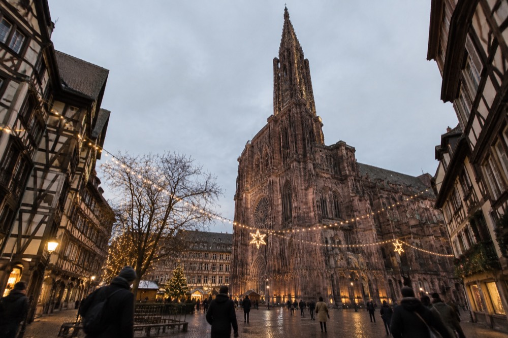 Festive lights above a square in Strasbourg at dusk in December