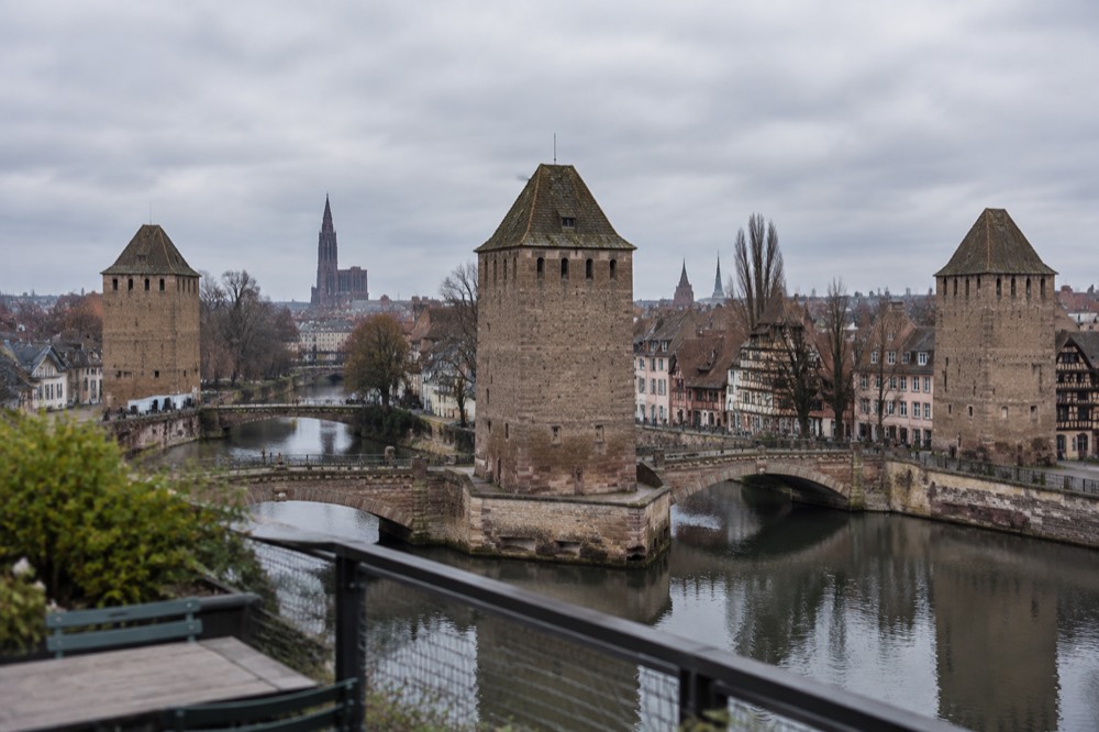 The rooftop terrace of the Barrage Vauban overlooking covered bridges and the city skyline