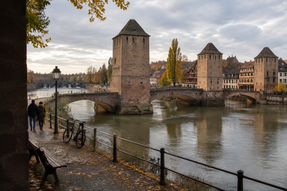 The Covered Bridges and the Barrage Vauban across the river Ill with autumn trees along the banks