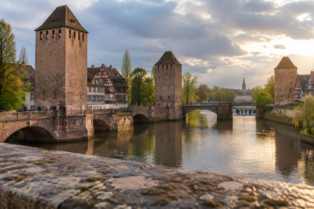 The Ponts Couverts towers and the Barrage Vauban seen across the Ill in spring