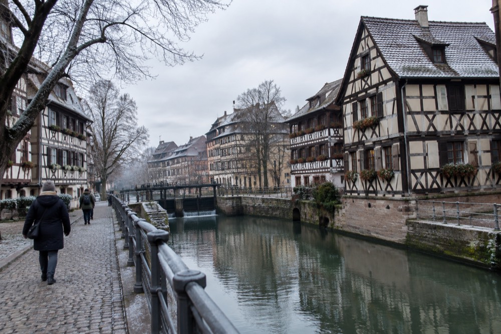Frosted half-timbered houses along a canal in Petite France on a cold morning