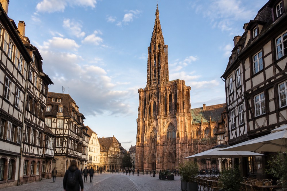 The single spire of Strasbourg Cathedral rising above rooftops on a clear day