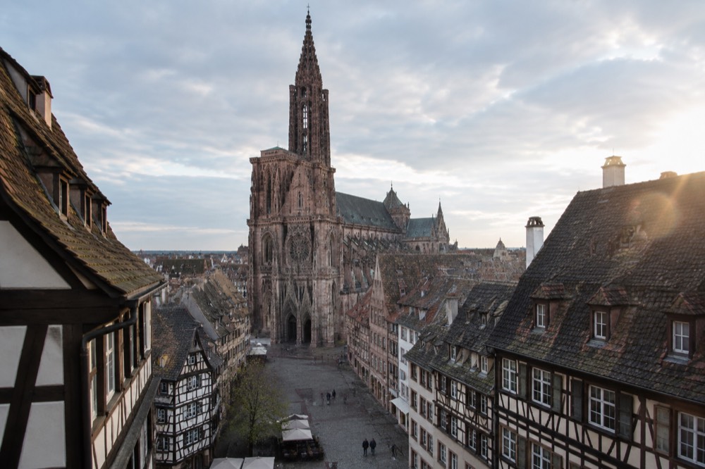 The single Gothic spire of Strasbourg Cathedral rising above rooftops on a clear day