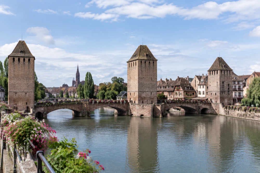 Flower-covered bridge and riverside houses along the Ill in Strasbourg
