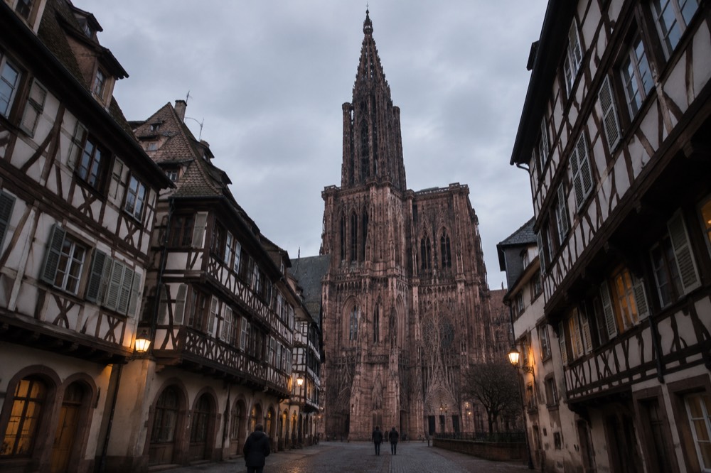 A quiet street of traditional Alsatian buildings in Strasbourg at dusk