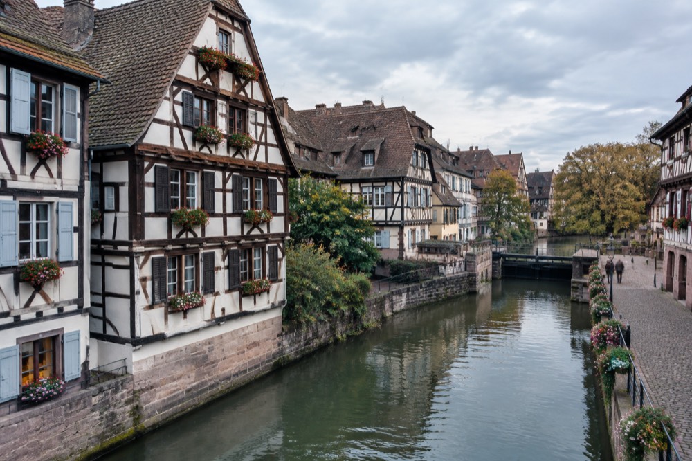 Half-timbered houses along a canal in Strasbourg's Petite France district at dusk