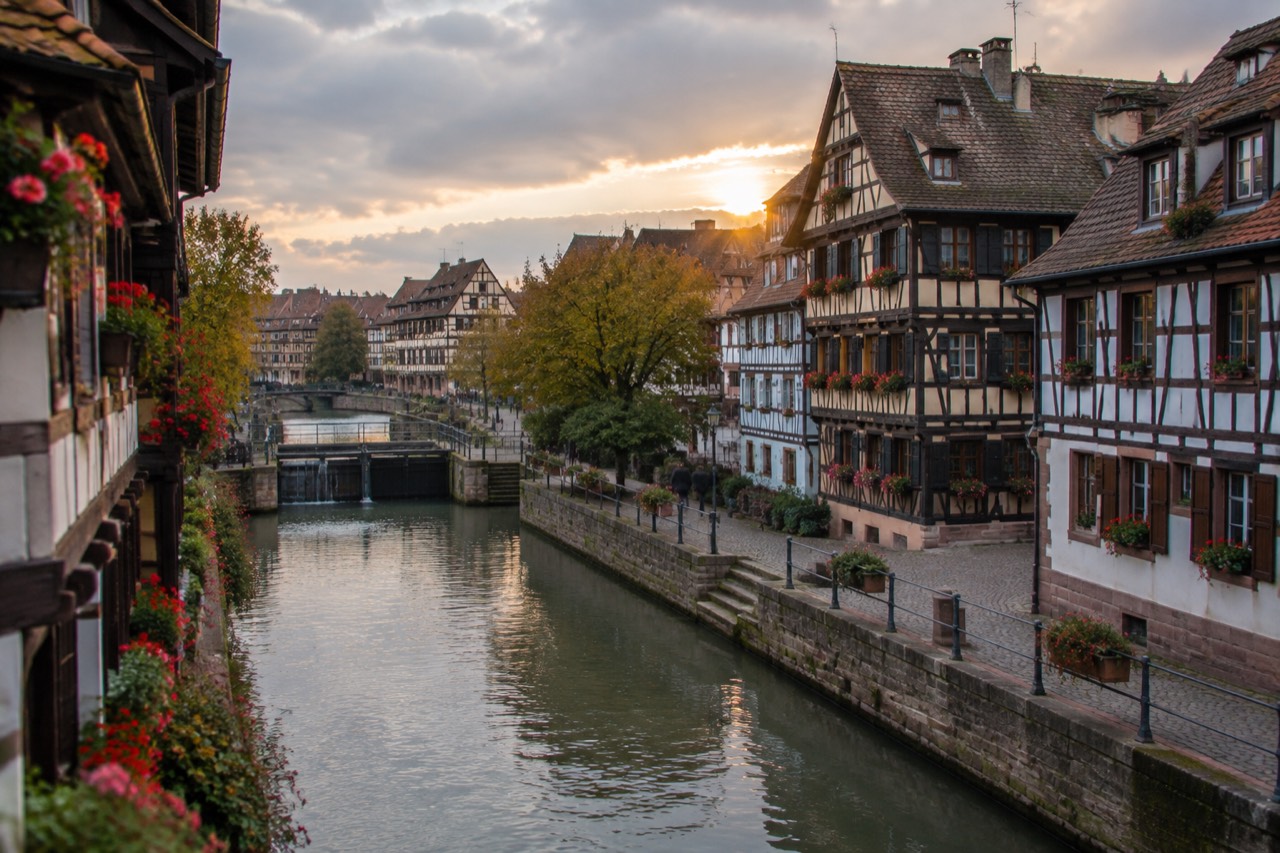 Half-timbered houses along a canal in Strasbourg's Petite France district at dusk