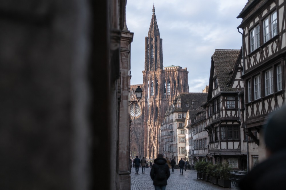 The single spire of Strasbourg Cathedral rising above red sandstone facades and rooftops