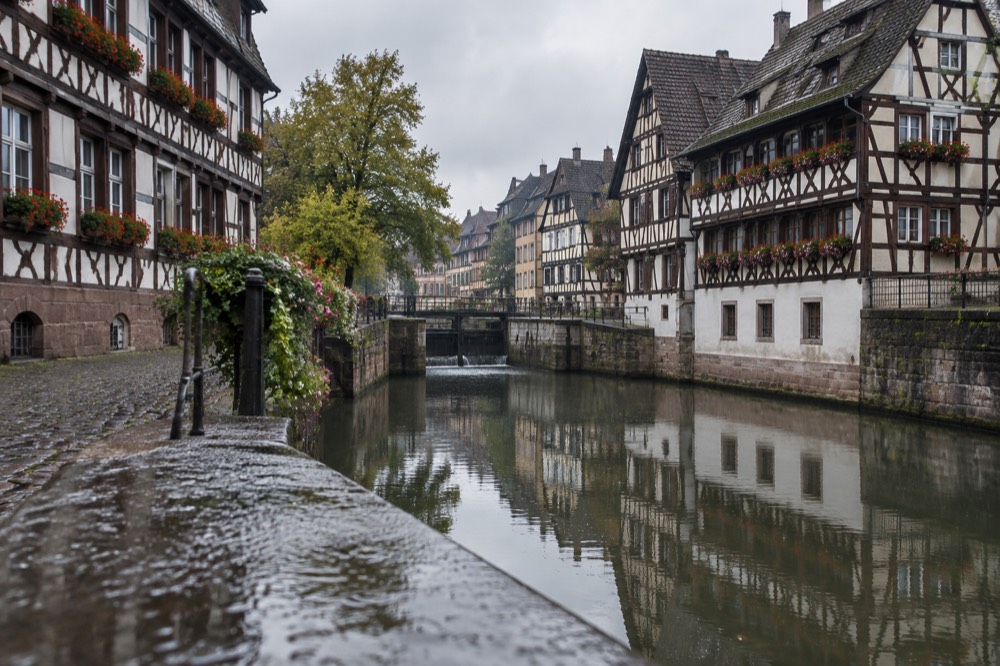 Half-timbered houses reflected in a calm canal in Strasbourg's Petite France quarter