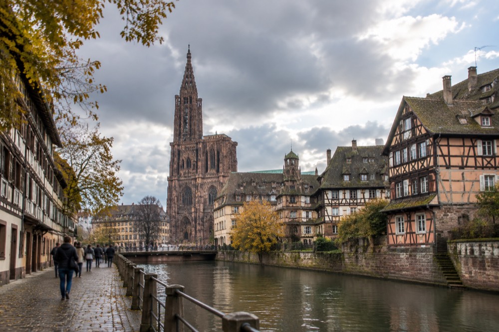 Autumn light on half-timbered facades along a Strasbourg canal