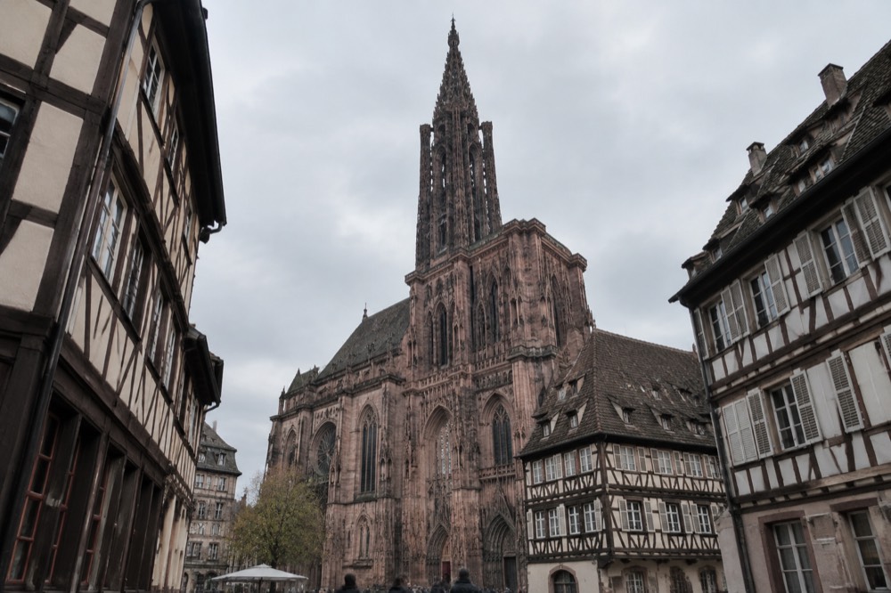 The single Gothic spire of Strasbourg Cathedral rising above rooftops