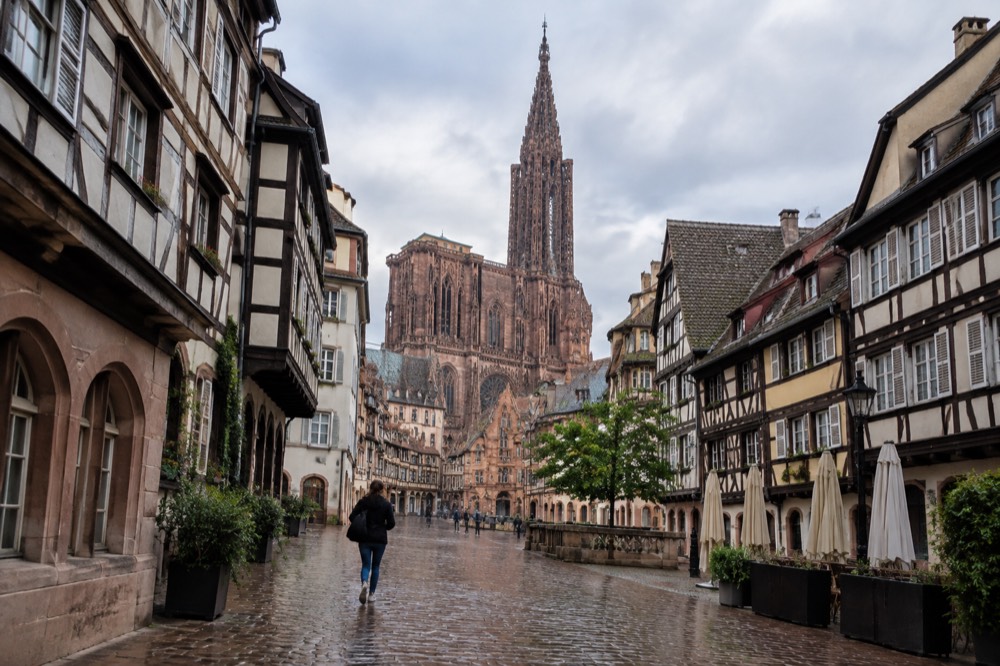 The single spire of Strasbourg Cathedral seen above the rooftops of the old town