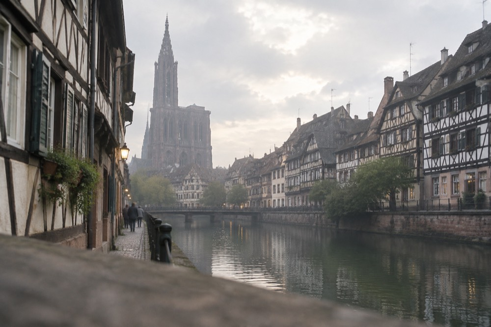 Half-timbered houses along a quiet canal in Strasbourg at dusk