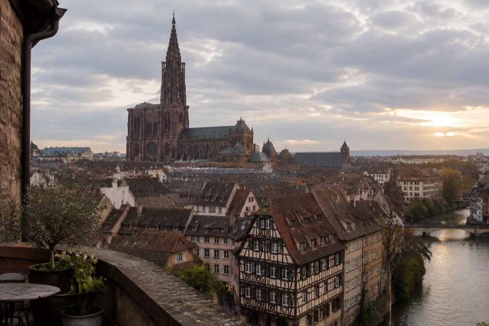 Rooftops of Strasbourg seen from a high terrace with the cathedral spire in the distance