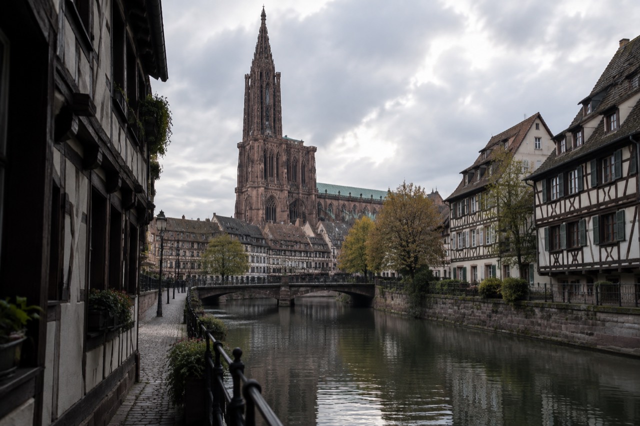 Half-timbered houses along a quiet canal in Strasbourg at dusk