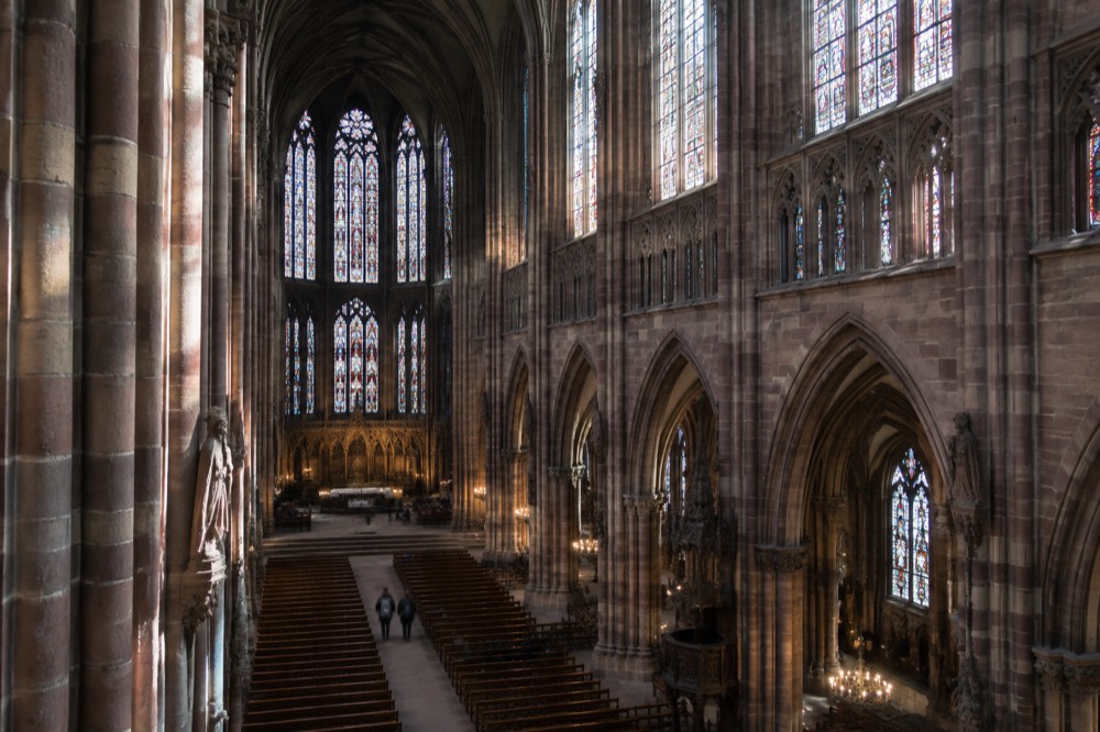 The Gothic interior of Strasbourg Cathedral with tall columns and stained glass