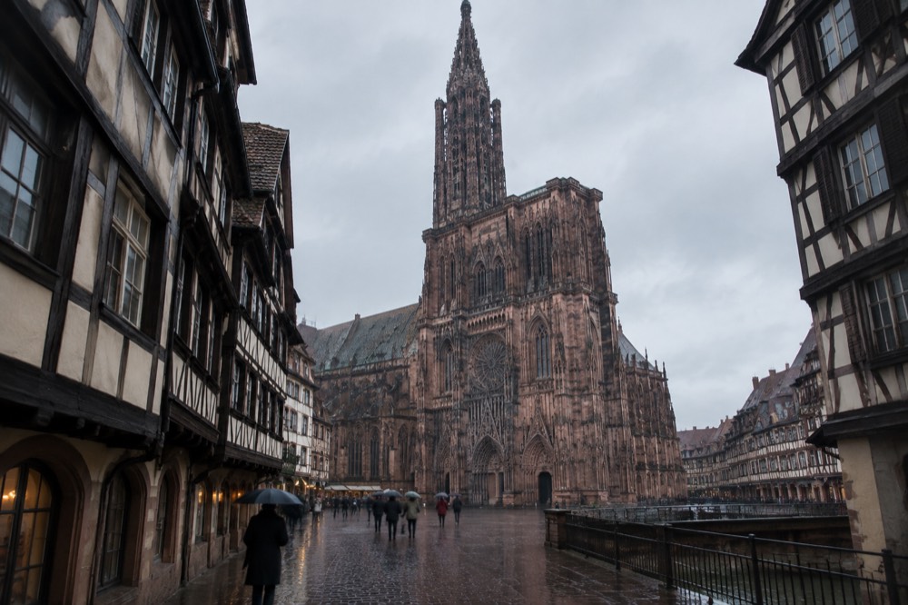 Rainy street with half-timbered houses and wet cobblestones in Strasbourg old town