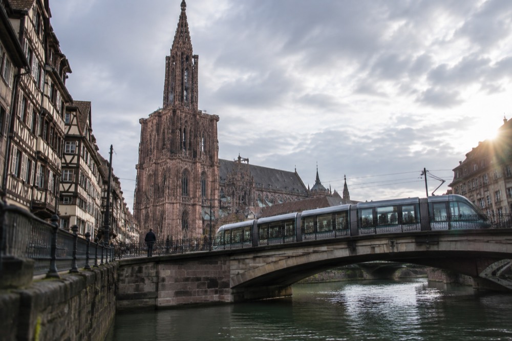 Modern tram crossing a bridge over the River Ill in central Strasbourg